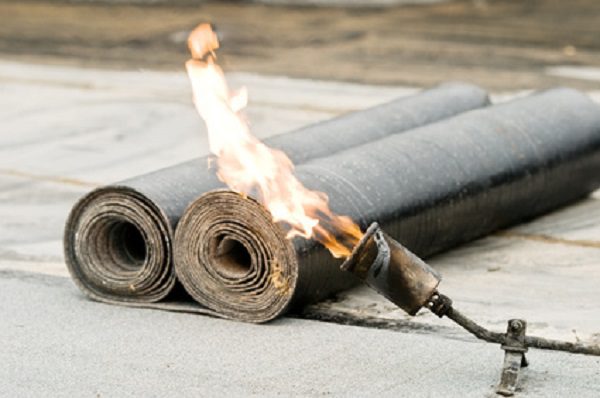 roofing felt roll and one torch blowpipes with open flame